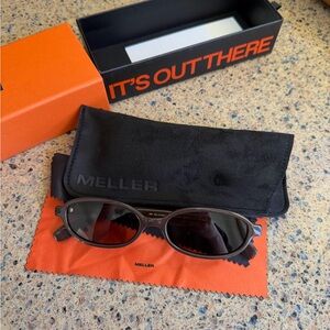Meller Oval Black Sunglasses with Orange Cleaning Cloth